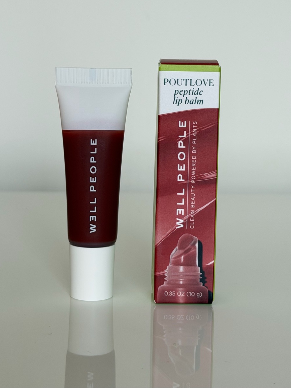 W3ll People Poutlove Peptide Lip Balm — Deep Berry Red honey plump